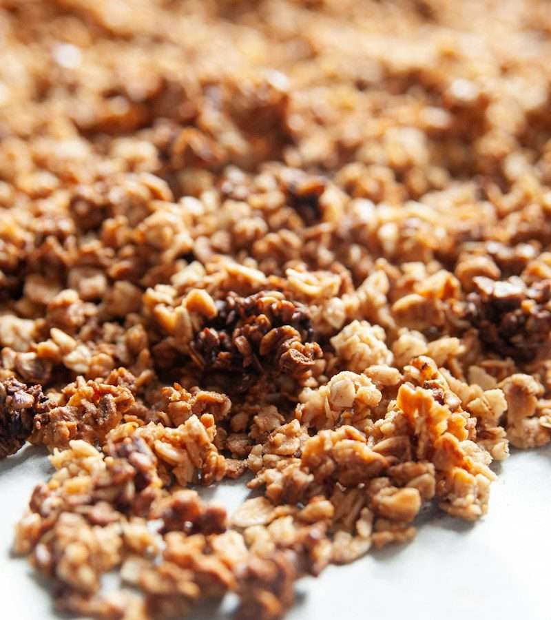 Receita de granola caseira com aveia, amêndoa, sementes e mel, feita no forno em 25 minutos. Quantidades, como fazer aglomerados e como conservar.